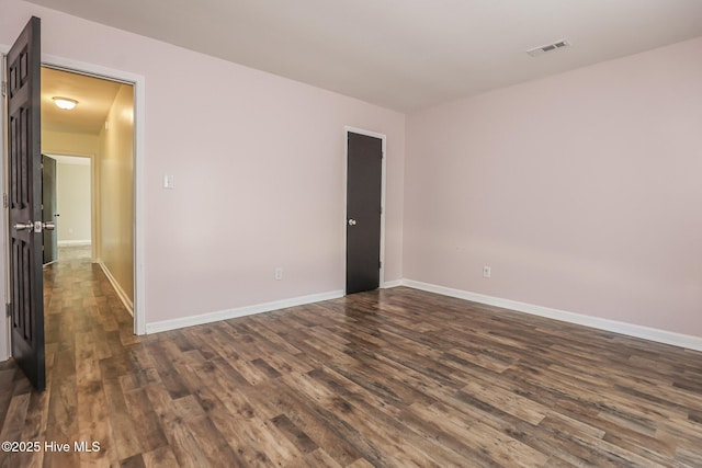 spare room with dark hardwood / wood-style flooring