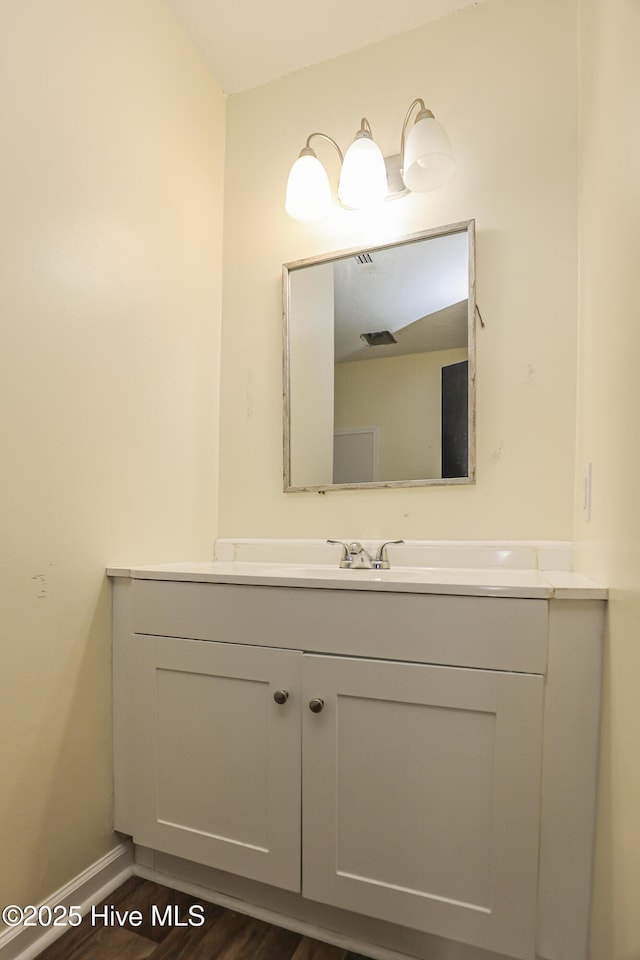 bathroom with vanity and hardwood / wood-style floors