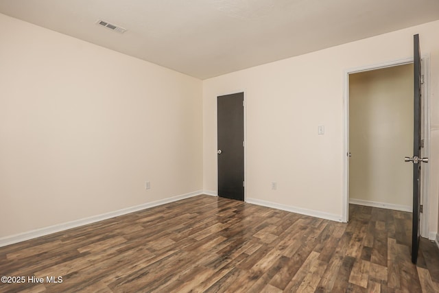 spare room with dark hardwood / wood-style floors