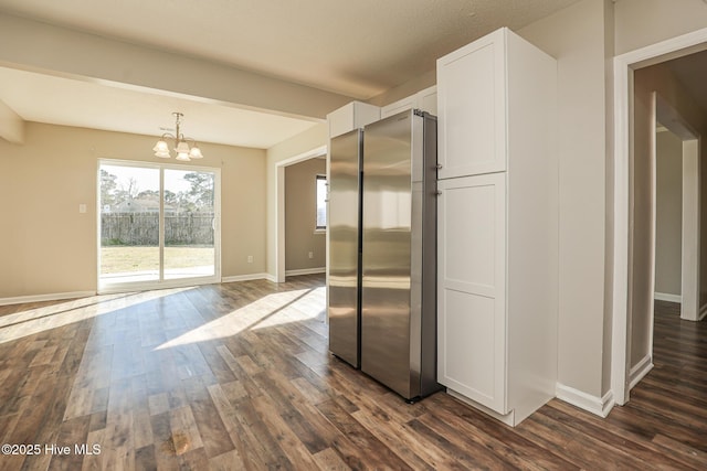 kitchen featuring white cabinetry, dark hardwood / wood-style floors, a chandelier, and stainless steel refrigerator