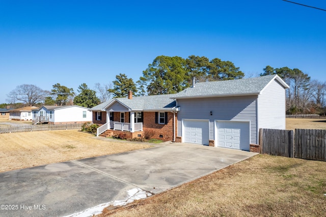 ranch-style home featuring a garage, a front yard, and a porch