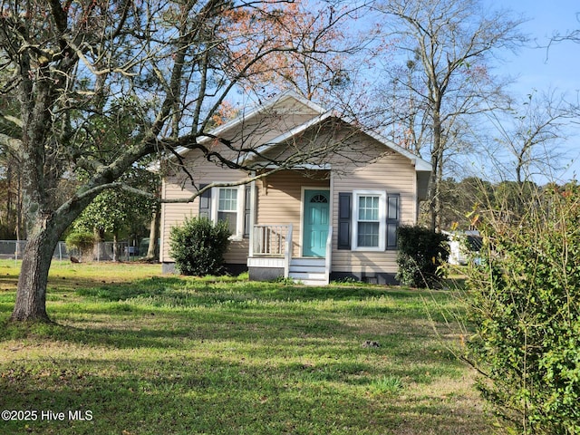 bungalow-style house featuring a front yard