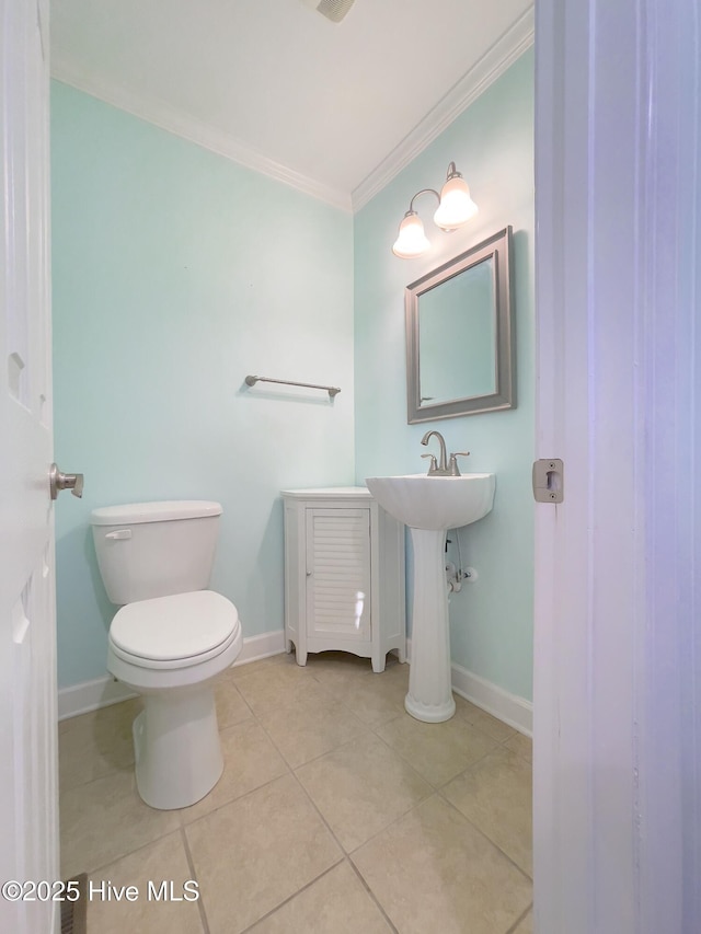 bathroom with ornamental molding, sink, tile patterned floors, and toilet