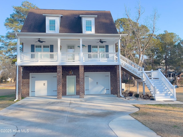 view of front of home featuring a garage, ceiling fan, and covered porch