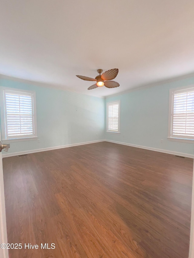 empty room featuring dark wood-type flooring and ceiling fan