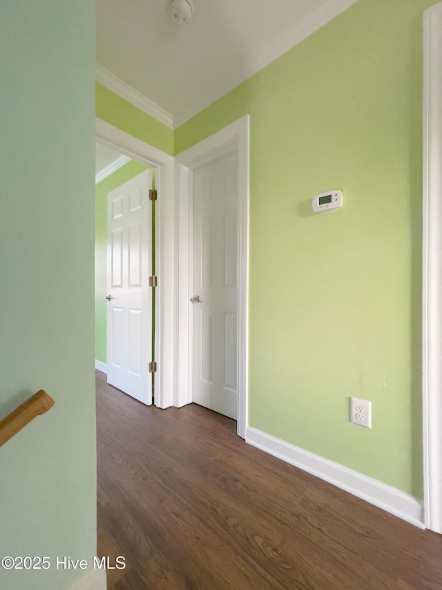 interior space with dark hardwood / wood-style flooring and crown molding