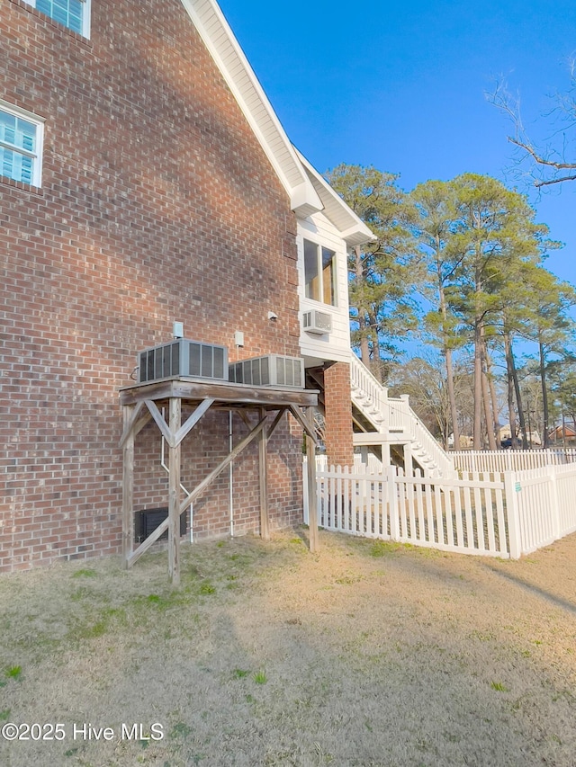 view of home's exterior featuring a yard and cooling unit