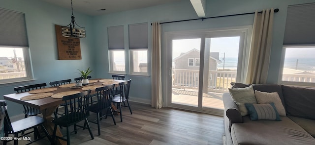 dining area featuring hardwood / wood-style flooring and a notable chandelier