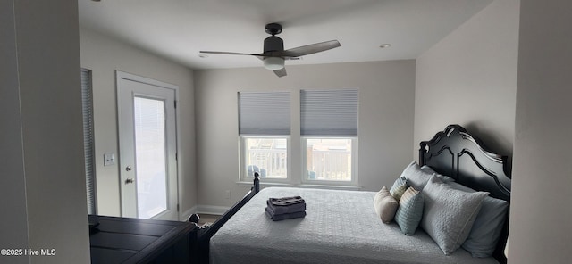 bedroom with multiple windows, hardwood / wood-style floors, and ceiling fan