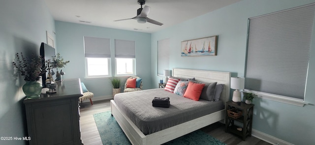 bedroom with hardwood / wood-style floors and ceiling fan