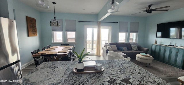 dining area featuring hardwood / wood-style flooring and ceiling fan