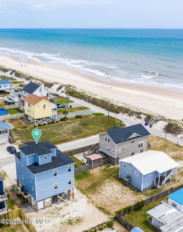 birds eye view of property featuring a water view and a view of the beach