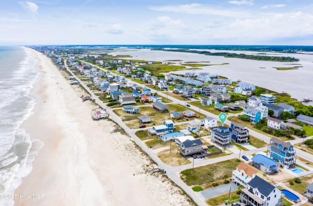 aerial view with a water view and a view of the beach