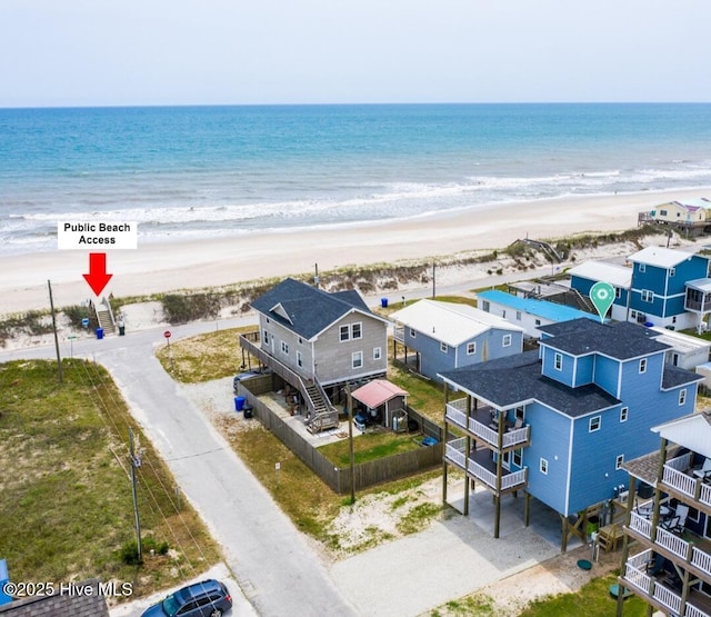 birds eye view of property featuring a view of the beach and a water view