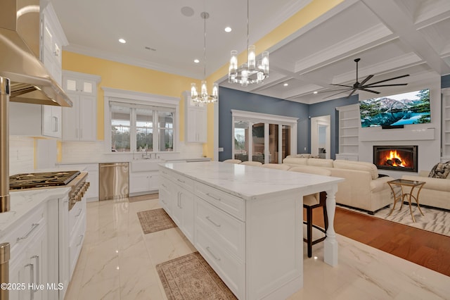 kitchen with dishwasher, white cabinetry, a center island, decorative light fixtures, and exhaust hood