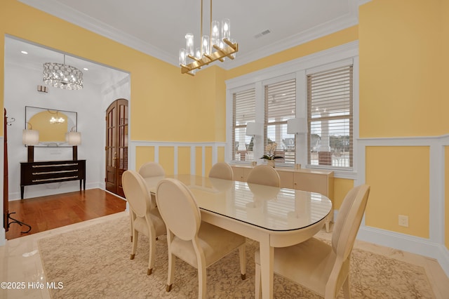 dining space with an inviting chandelier and crown molding