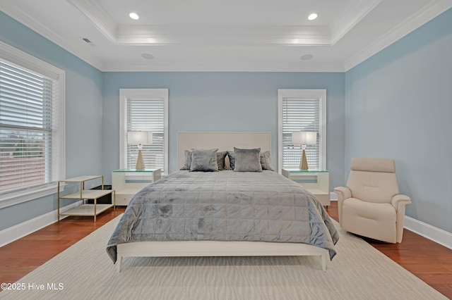 bedroom featuring crown molding, a tray ceiling, and dark hardwood / wood-style flooring