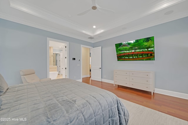 bedroom with crown molding, a tray ceiling, ceiling fan, and light wood-type flooring