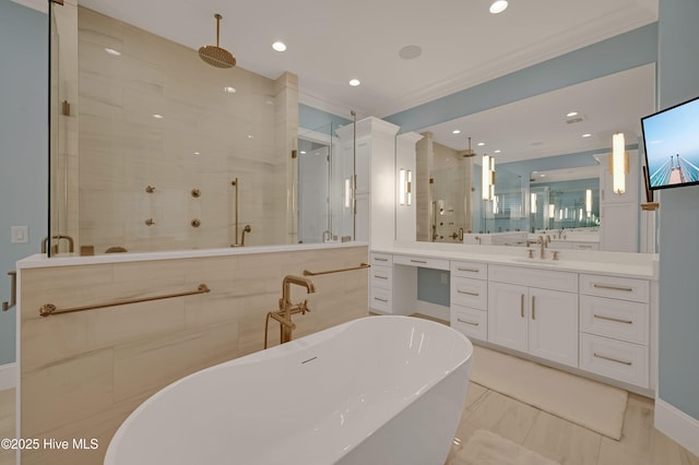 bathroom with vanity, ornamental molding, and separate shower and tub