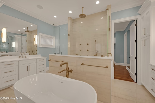 bathroom featuring crown molding, vanity, and shower with separate bathtub