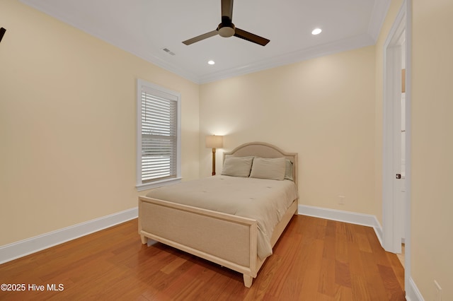 bedroom featuring ceiling fan, ornamental molding, and hardwood / wood-style floors