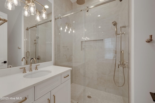 bathroom featuring walk in shower and vanity