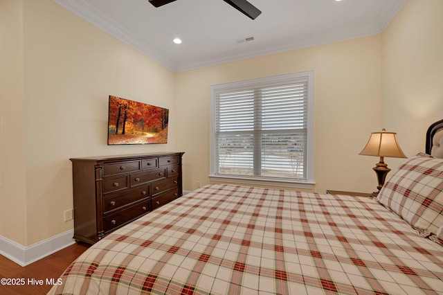 bedroom featuring crown molding, ceiling fan, and light wood-type flooring