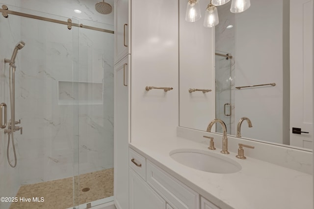 bathroom with vanity and a shower with shower door