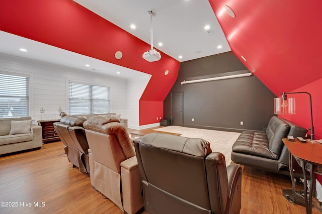 cinema featuring lofted ceiling and light hardwood / wood-style flooring