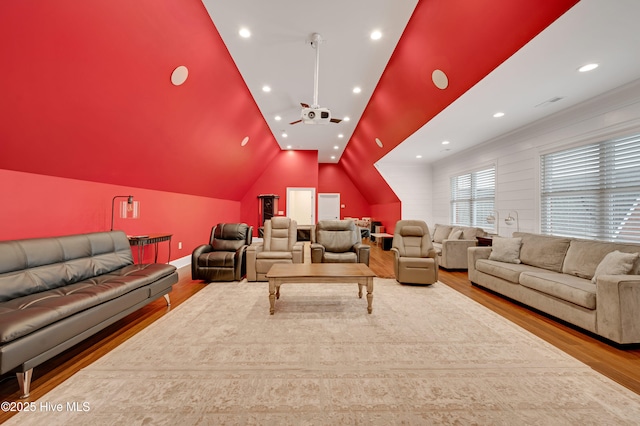 home theater featuring lofted ceiling and light wood-type flooring