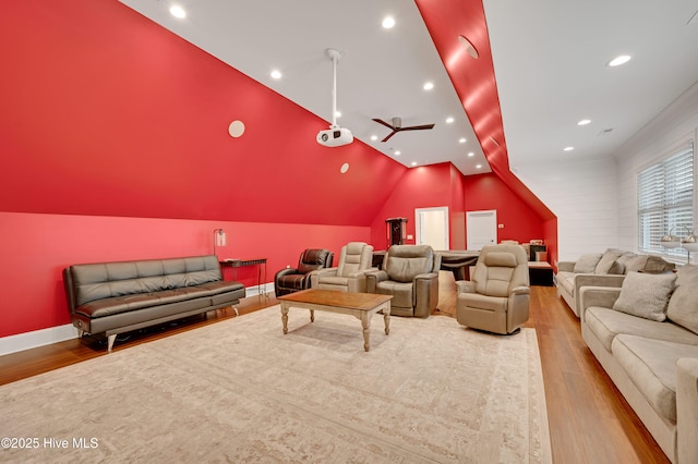 cinema room featuring lofted ceiling and wood-type flooring