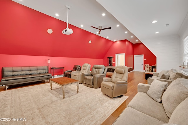 cinema room featuring vaulted ceiling and light hardwood / wood-style floors