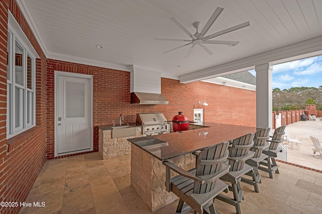 view of patio / terrace with an outdoor kitchen, ceiling fan, area for grilling, and an outdoor wet bar