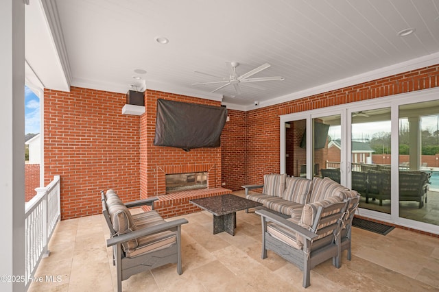 view of patio / terrace featuring an outdoor living space with a fireplace and ceiling fan