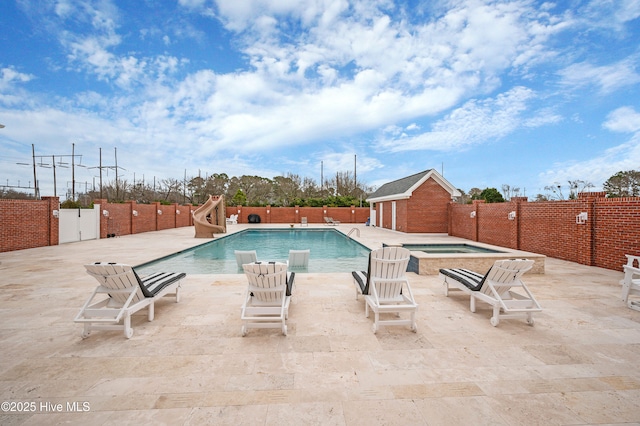 view of pool featuring a hot tub and a patio