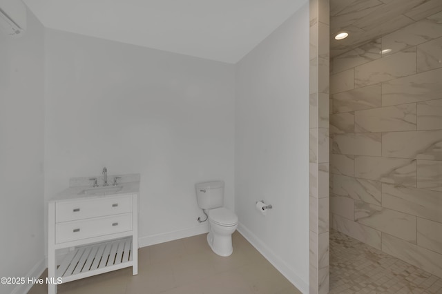 bathroom with vanity, toilet, and a tile shower