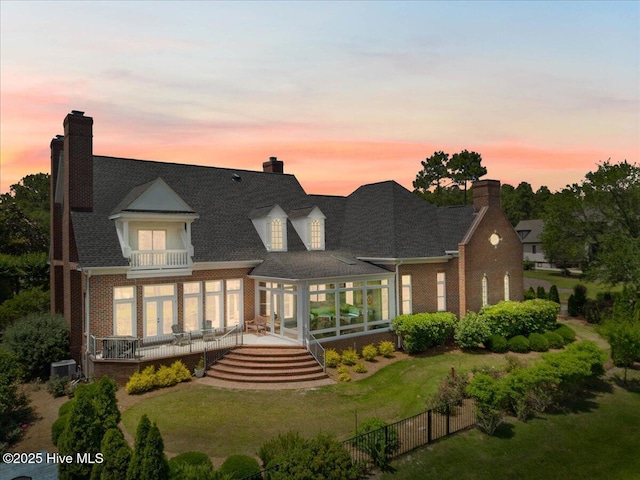 4174 Brookfield Way, Southport, NC 28461 - back of property at dusk featuring a balcony, french doors, and brick siding