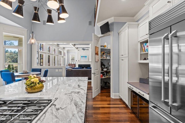 4174 Brookfield Way, Southport, NC 28461 - kitchen with appliances with stainless steel finishes, dark wood-style floors, white cabinetry, light stone countertops, and ornamental molding