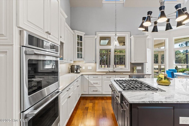 kitchen with a sink, white cabinetry, and appliances with stainless steel finishes