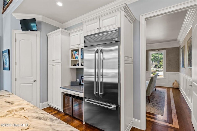 kitchen featuring dark wood-type flooring, light countertops, white cabinetry, and stainless steel built in refrigerator