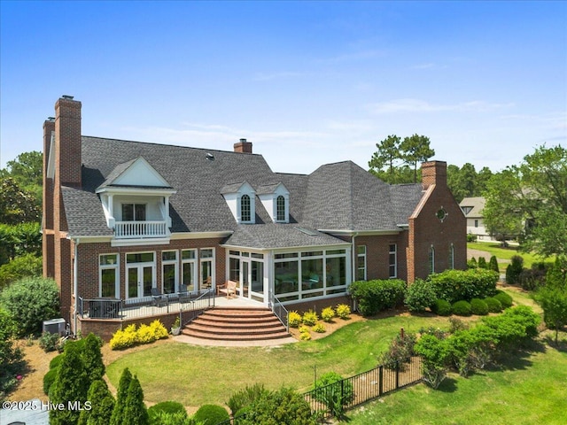 4174 Brookfield Way, Southport, NC 28461 - rear view of house with a balcony, a chimney, a sunroom, and brick siding