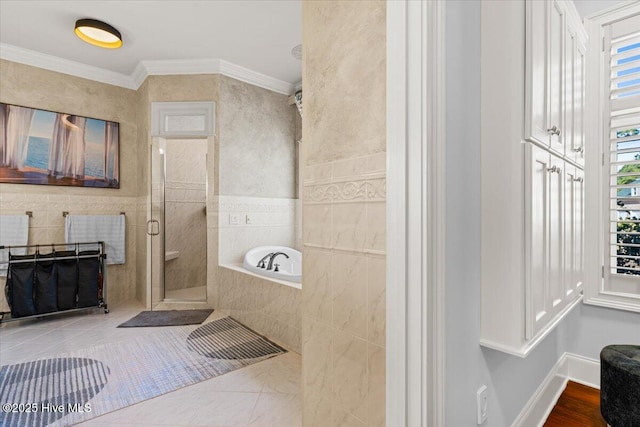 bathroom featuring ornamental molding, a stall shower, and a garden tub