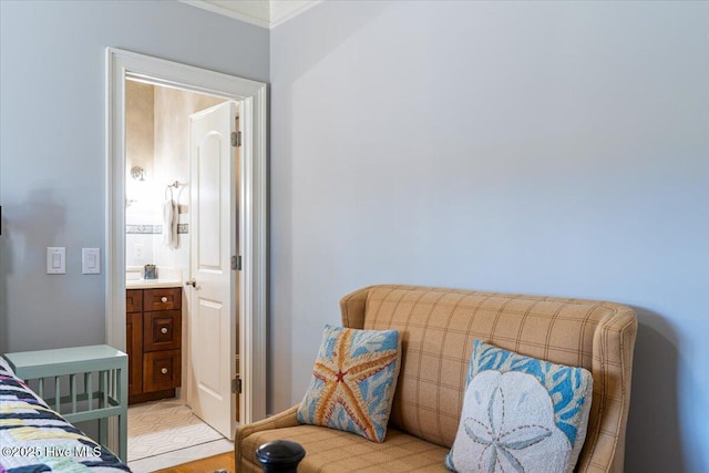 bedroom featuring ornamental molding and connected bathroom