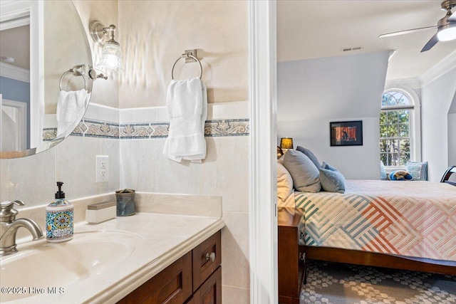 bathroom with a ceiling fan, visible vents, crown molding, vanity, and ensuite bath