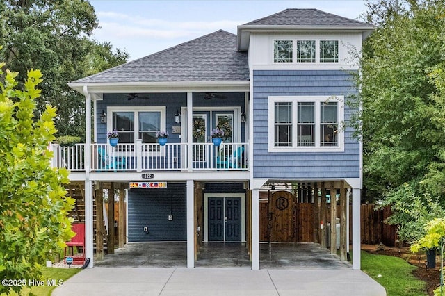 view of front of property featuring ceiling fan, a carport, and a balcony