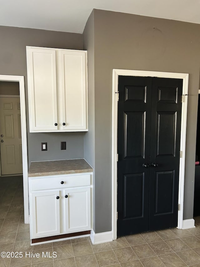kitchen featuring white cabinetry and light tile patterned floors