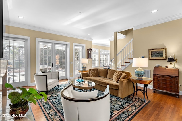 living room with french doors, ornamental molding, and hardwood / wood-style floors