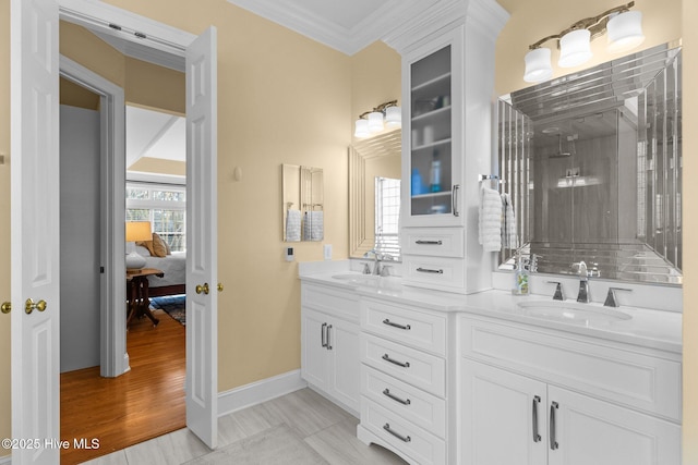 bathroom with vanity, hardwood / wood-style floors, and crown molding