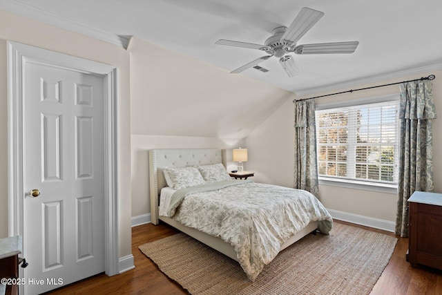 bedroom featuring dark wood-type flooring, ceiling fan, and vaulted ceiling