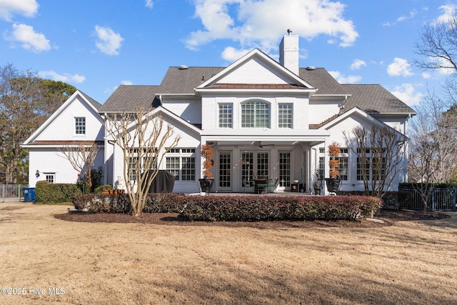 back of property featuring a patio and a yard